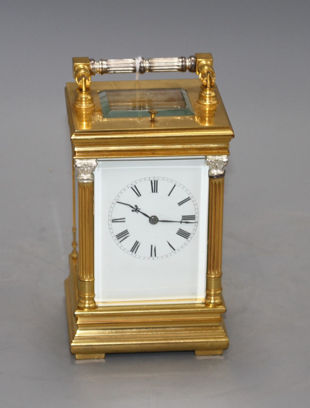 A 20th century silvered and gilt quarter repeating carriage clock